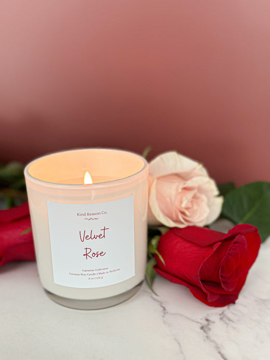 Candle labeled 'Velvet Rose' with a pink and red rose in the background